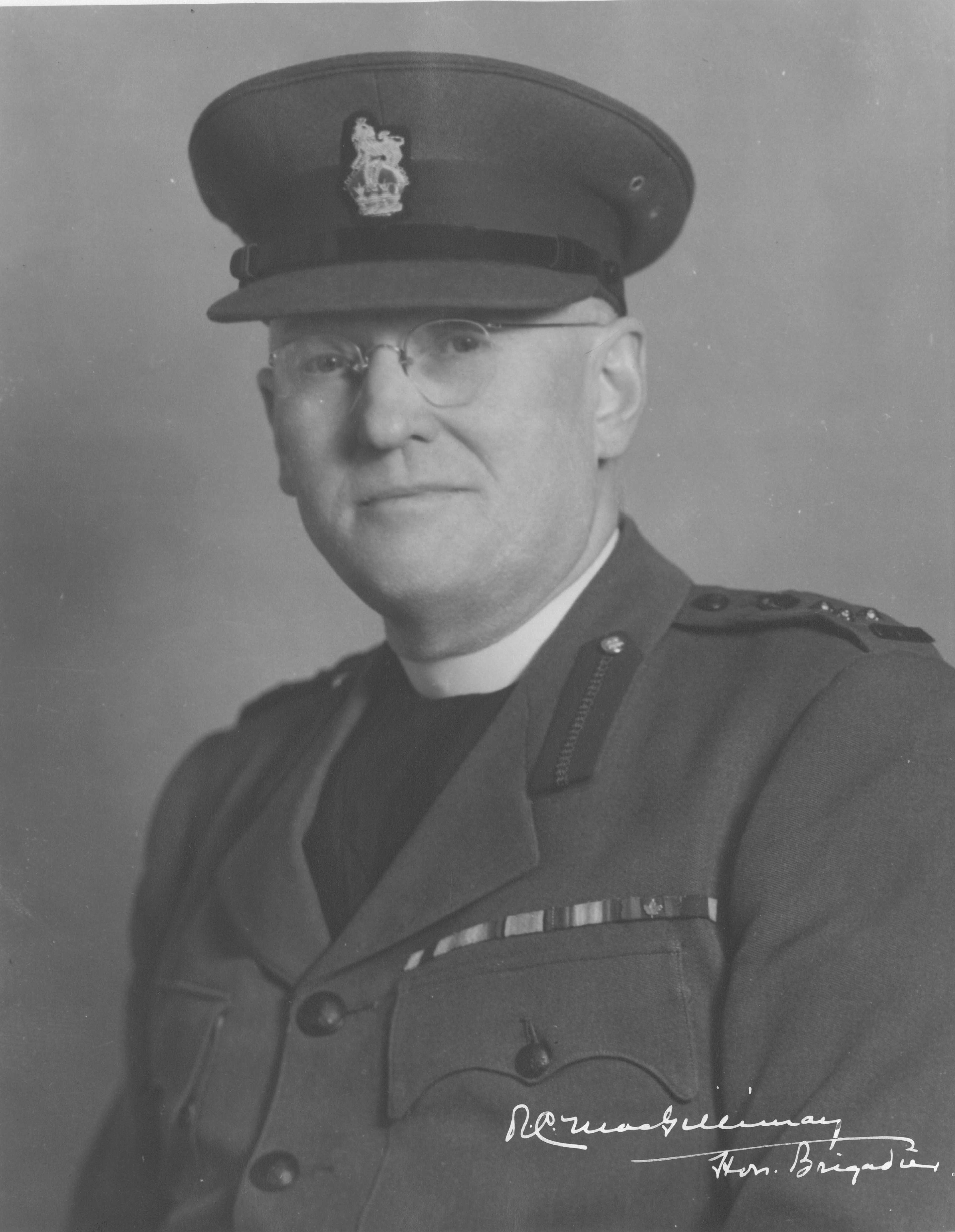 Portrait en noir et blanc – MacGillivray est photographié à partir de la poitrine. Ses barrettes auxquelles sont fixées des décorations pour service méritoire sont visibles sur sa veste. Il porte un uniforme militaire ainsi qu’un chapeau.